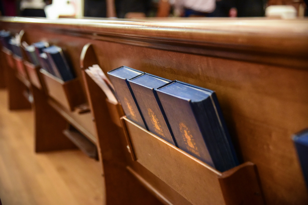 church pew with hymnals